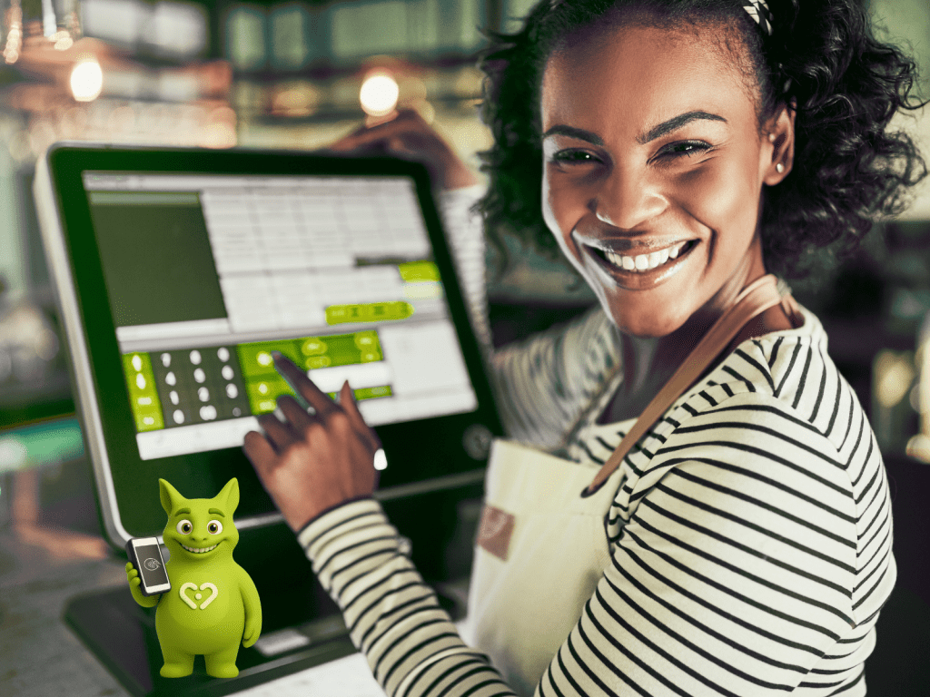 Smiling staff member using POS system, Tuutuu mascot holding smartphone with payment icon.